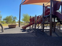 a playground with a slide and swings