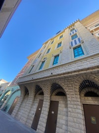 a building with arches and a blue sky