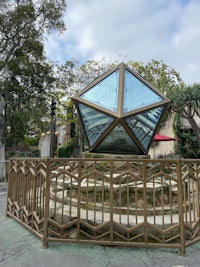 a large glass dome in the middle of a park